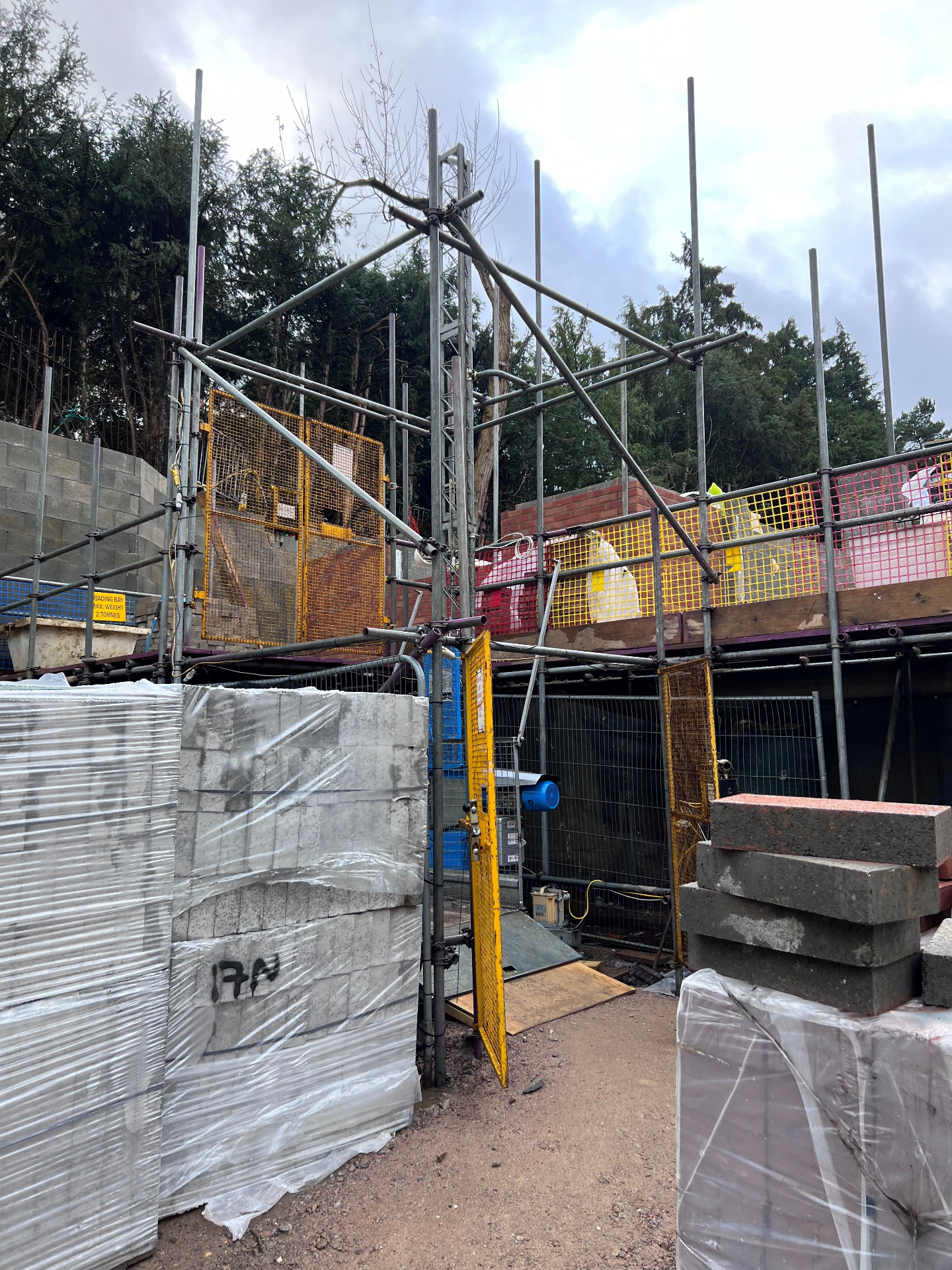 Hoist & Lifting Scaffolding - Armstrong Scaffolding Armstrong Scaffolding hoist and lifting setup with material loading bay on a residential construction site in Kent