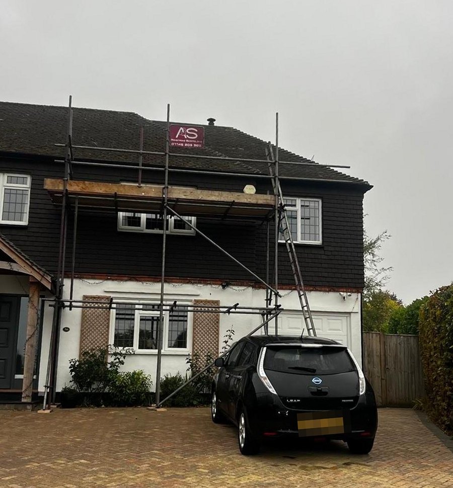Gutter Repair Access Scaffolding, Sevenoaks - Armstrong Scaffolding Gutter repair access scaffolding on a semi detached house in Sevenoaks, boarded platform across the front elevation standing on the block paved driveway