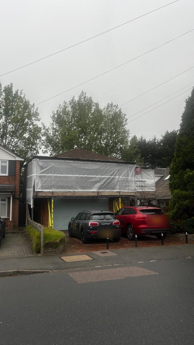 Temporary Roof Over a Garage, Petts Wood - Armstrong Scaffolding Armstrong Scaffolding temporary roof sheeted over a domestic garage in Petts Wood, with the driveway still in use underneath